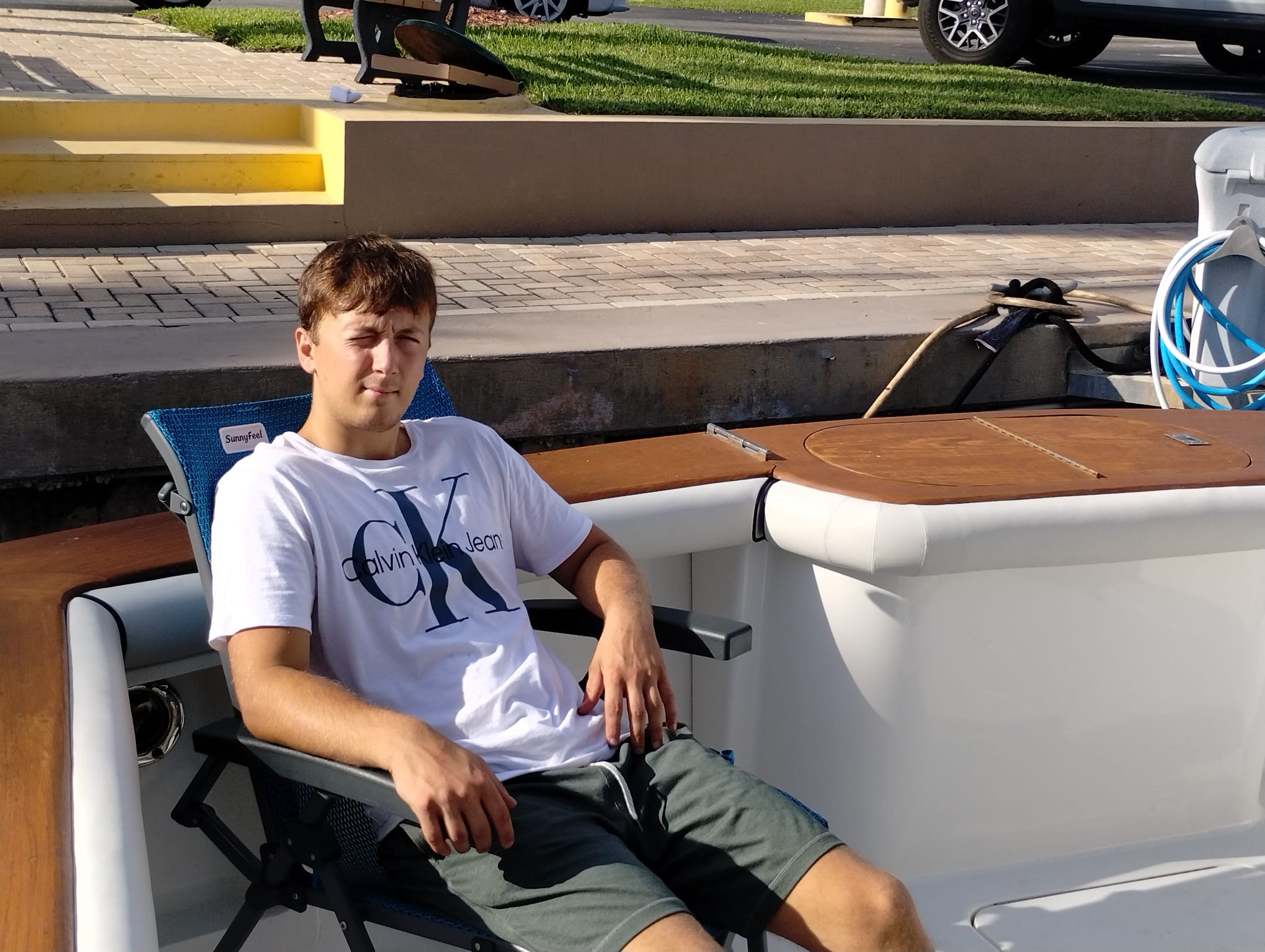 An image depicting the business owner next to custom upholstered bolsters in extreme heat.
