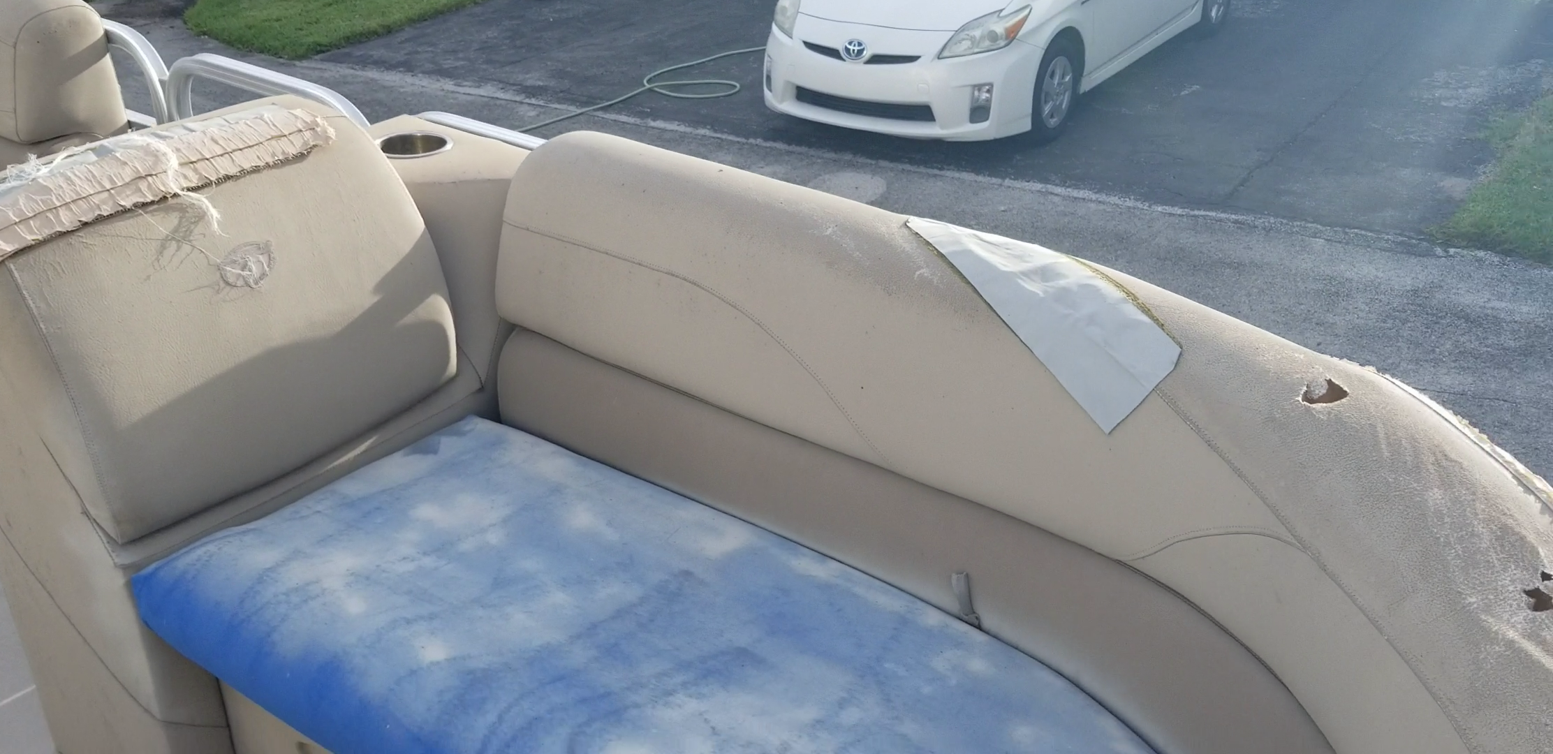 Worn boat seat cushions on the right side before marine upholstery restoration