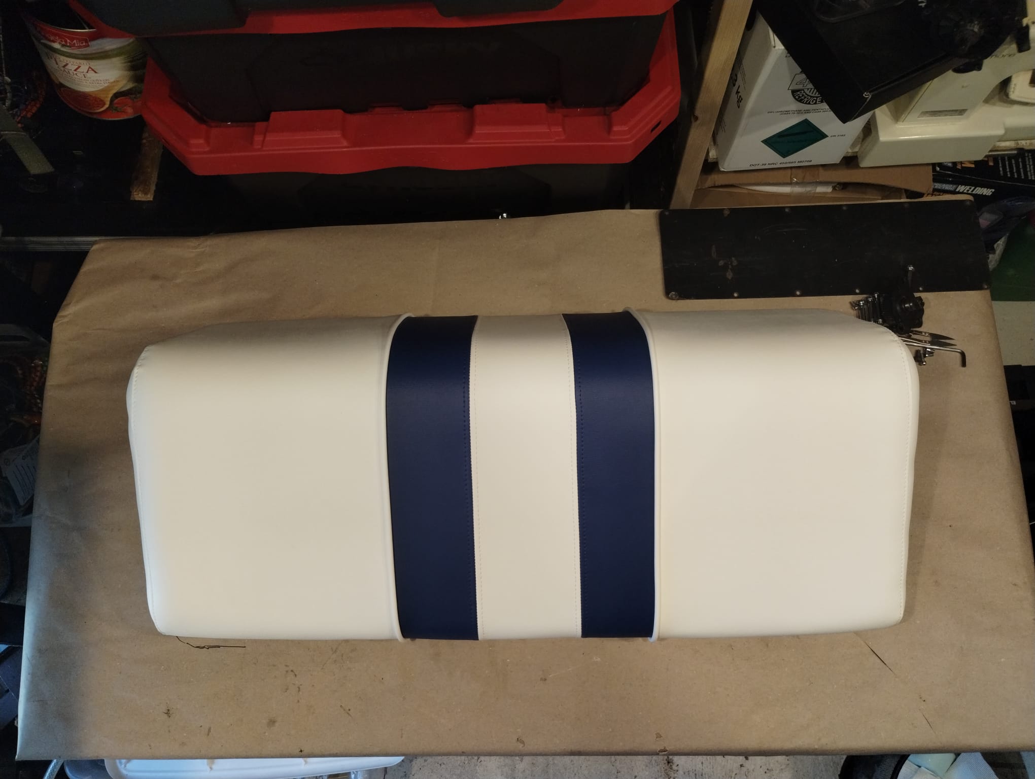 New boat bench seat cushion reupholstered in white marine vinyl with navy blue stripes