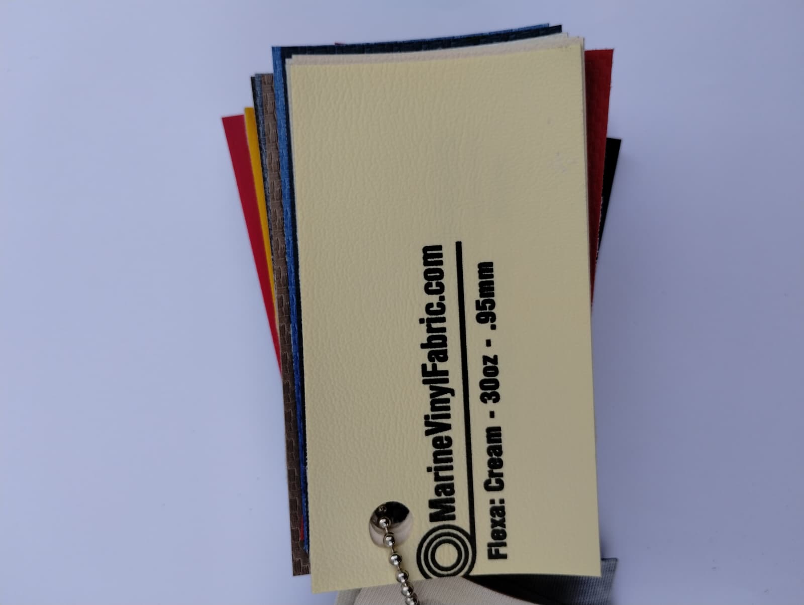 Cream Flexa marine vinyl upholstery fabric swatch on a sample ring, 30oz and 0.95mm marine grade
