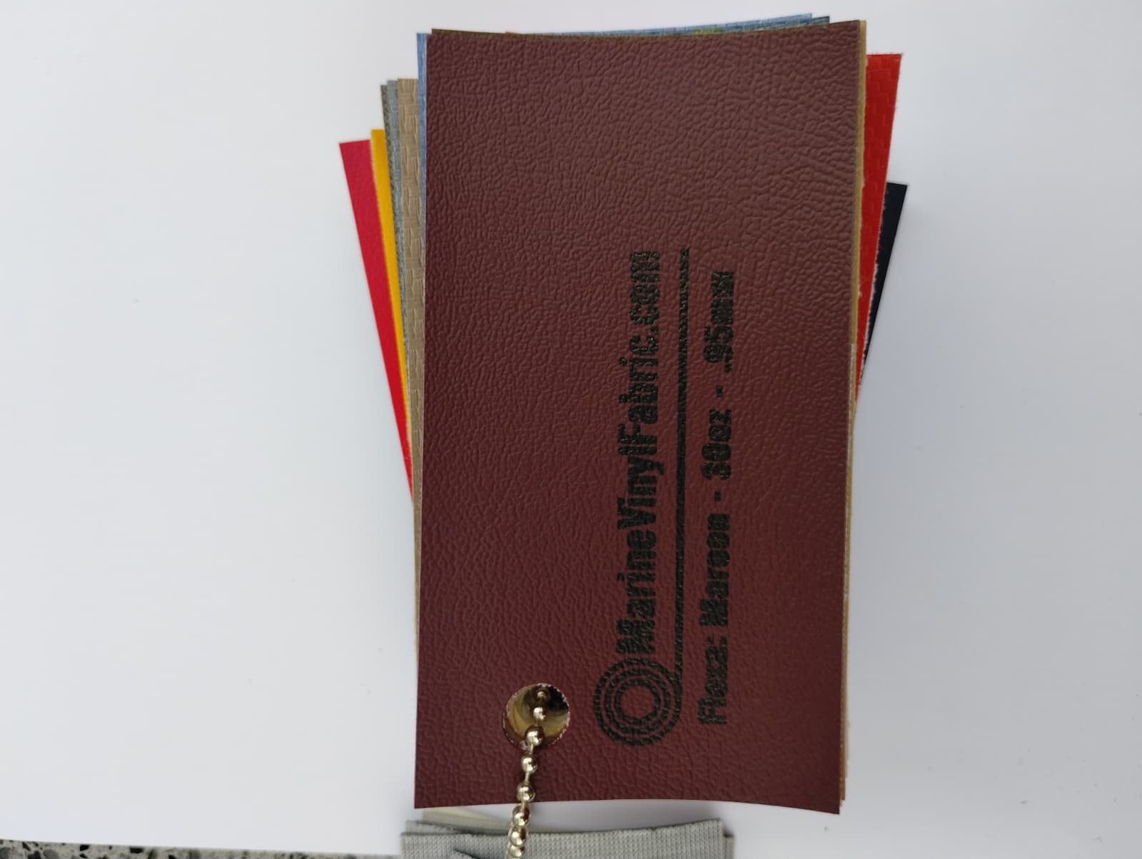 Maroon Flexa marine vinyl upholstery fabric swatch on a sample ring, 30oz and 0.95mm marine grade