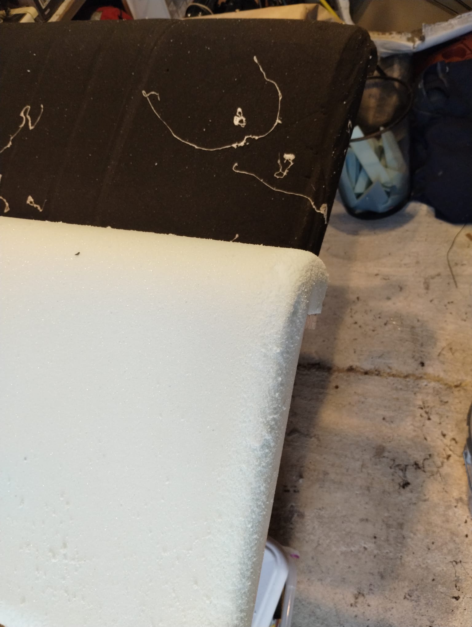 Moldy Foam Close-Up Black mold on old boat seat foam edge beside clean new replacement foam