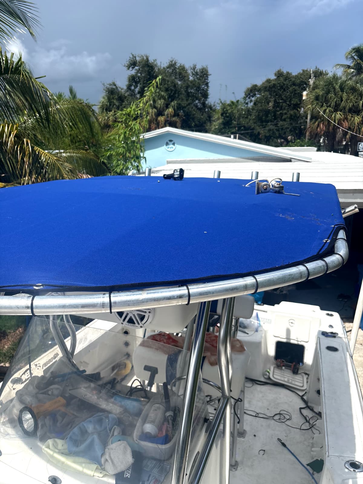 New royal blue marine canvas T-top fitted on a center console boat after canvas replacement