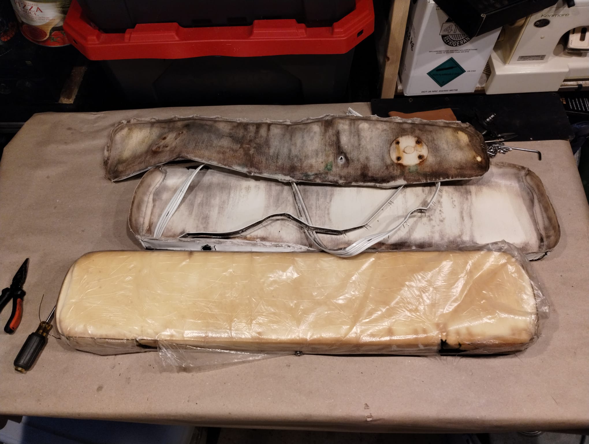 Old Moldy Boat Cushions Three heavily moldy boat seat cushions waiting for foam replacement, one new cushion wrapped and ready
