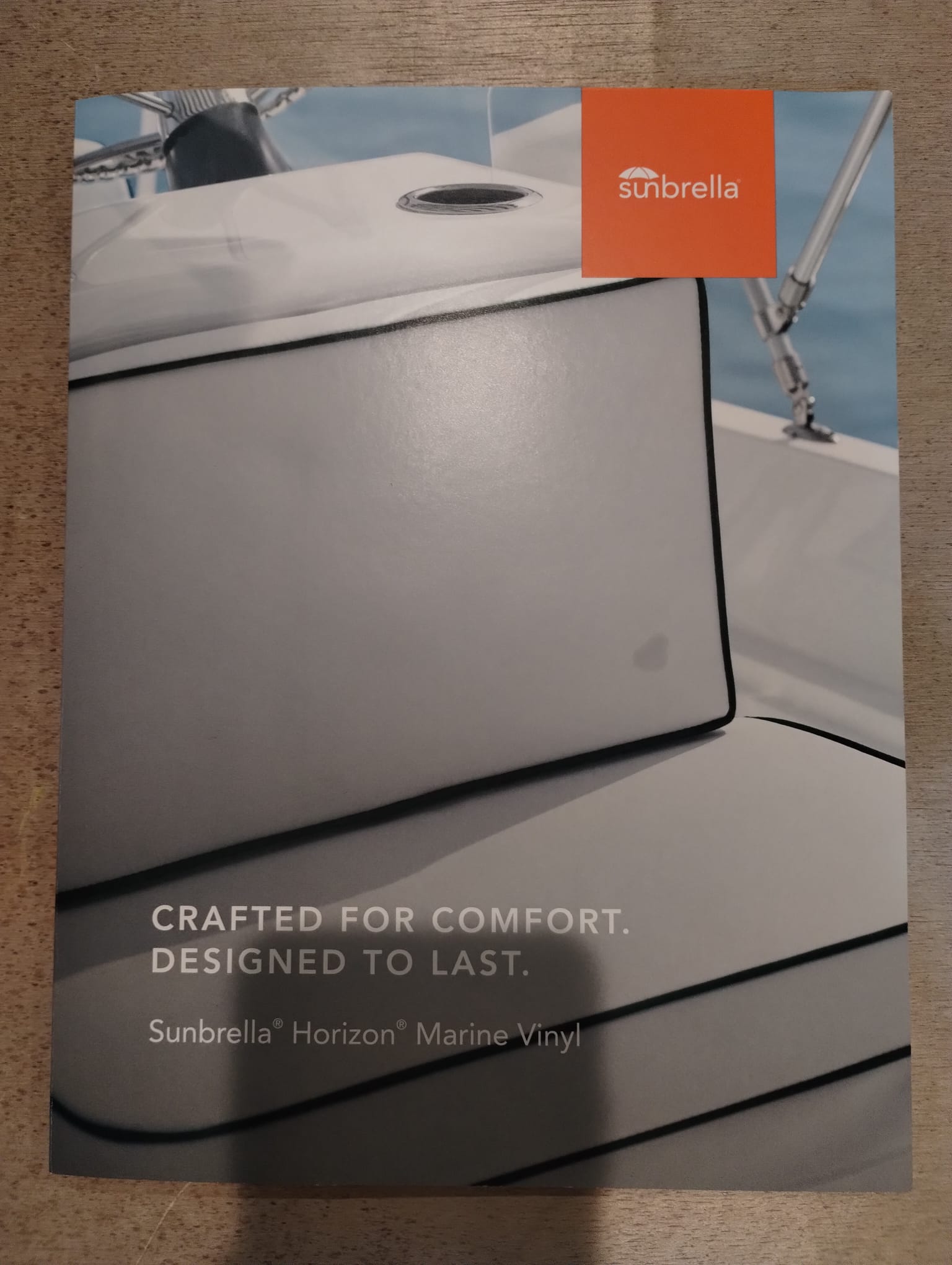 Sunbrella Horizon marine vinyl swatch book cover showing upholstered boat seating